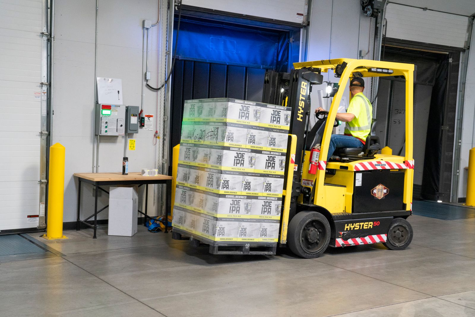 Forklift carrying a pallet of packed boxes